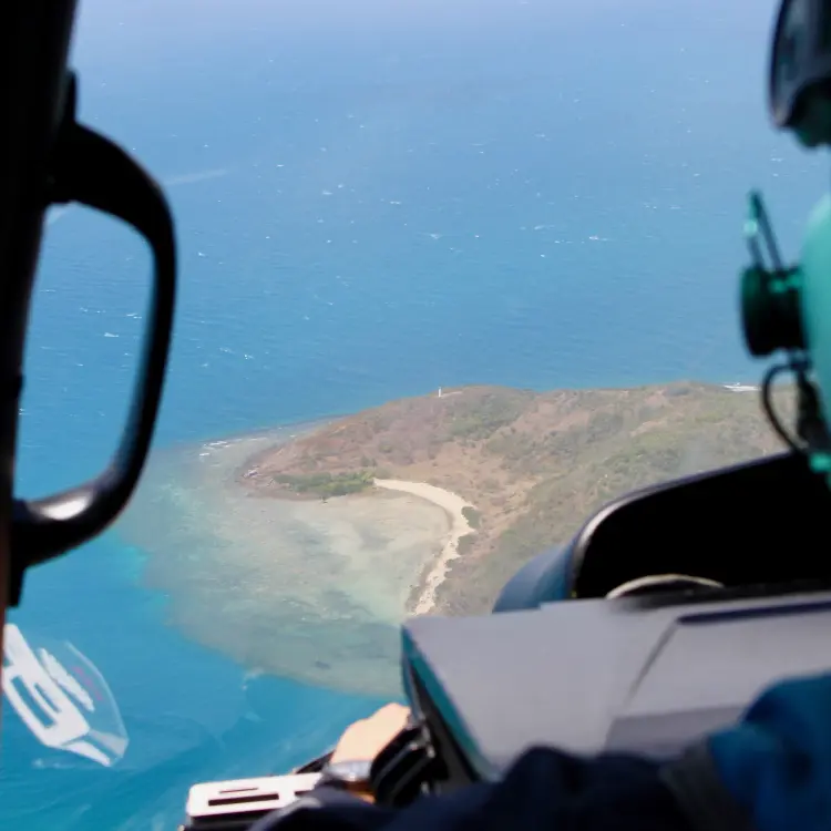 Aerial view of the Australian coastline from a helicopter cockpit.
